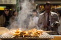 Grilled seafood scallop and sea Ã¢â¬â¹Ã¢â¬â¹urchin eggs skewer with smoke, japanese street food at Tsukiji Fish Market, Japan. selective